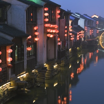 Traditional old riverside houses illuminated at night in Shantang water town, Suzhou, Jiangsu Province, China, Asia