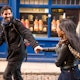 Couple running through Dublin's Temple Bar.