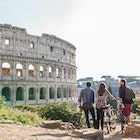 Three happy young friends tourists with bikes at Colosseum in Rome having fun
1162952296