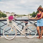 Shot of a young woman touring the city of Paris with a bicycle
1180138804
