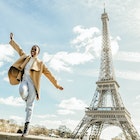 A Black woman dancing near the Eiffel Tower in Paris