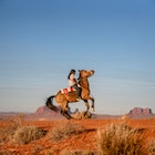 A Dine boy rides his horse in the Navajo Nation in the southwestern United States