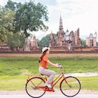 1284234549
an asian female tourist sightseeing Sukhothai historical park on a bicycle.