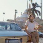 Woman in headscarf standing near the vintage car on the background of Mosque of Muhammad Ali
1303199526