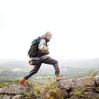 Older woman happily trekking in the mountains around Kenmare.