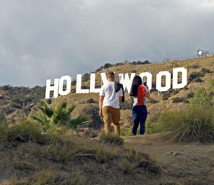 Hollywood, California/ USA  11-21-19 Two young people hiking in Hollywood California's Griffith Park stop to  admire a famous sign in the Hollywood Hills; Shutterstock ID 1575362842; full: 65050; gl: Lonely Planet Online Editorial; netsuite: Best hikes in LA; your: Brian Healy
1575362842
adventure, america, american, blue, california, destinations, famous, griffith, high, hike, hiking, hill, hills, hillside, hollywood, iconic, la, landmark, landscape, los angeles, monica, mount, mountain, nature, outdoor, park, people, rock, santa, santa monica, sight, sightseeing, sky, summer, tourism, tower, trail, travel, trekking, usa, vacation, view, western, white