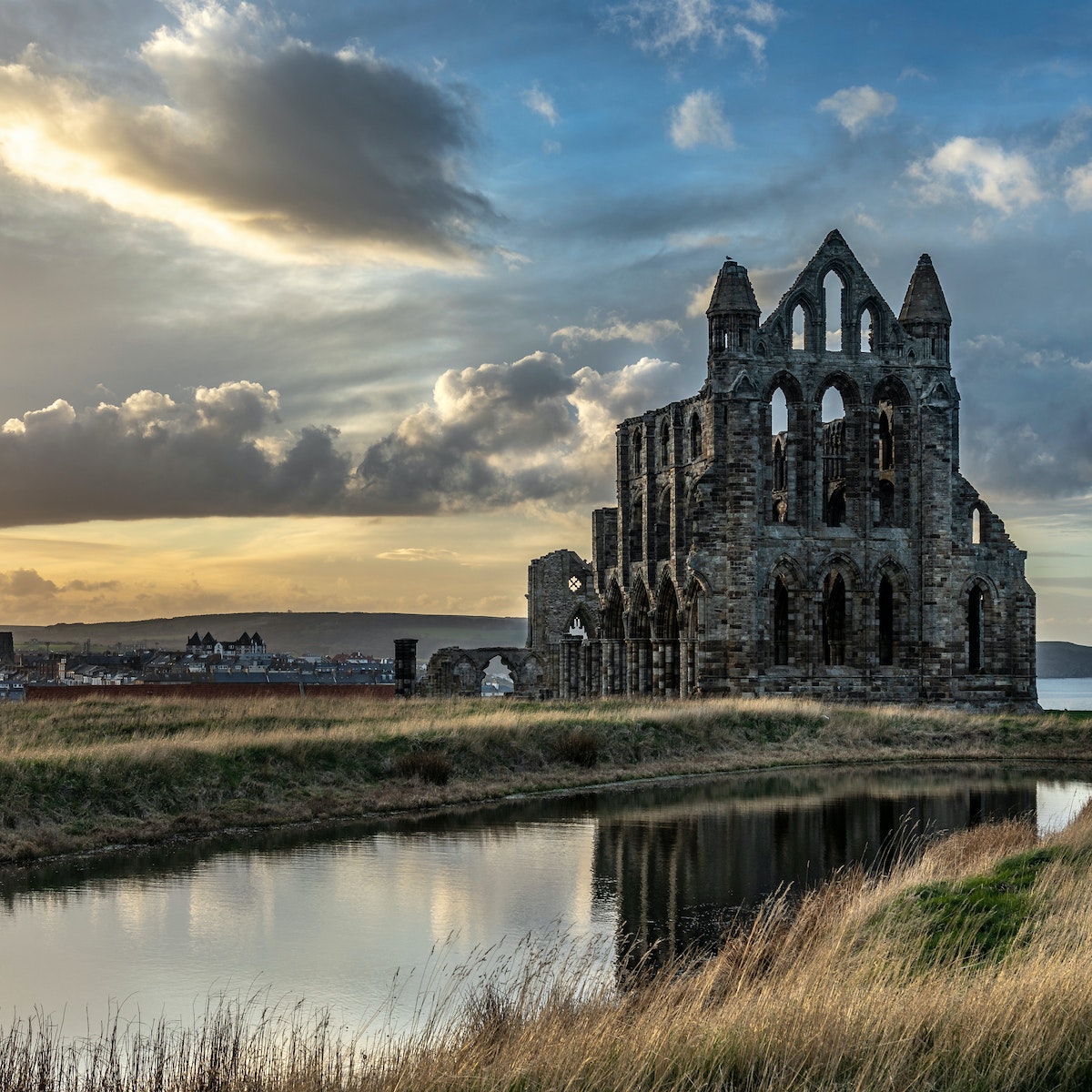 Exterior of Whitby Abbey during sunset.